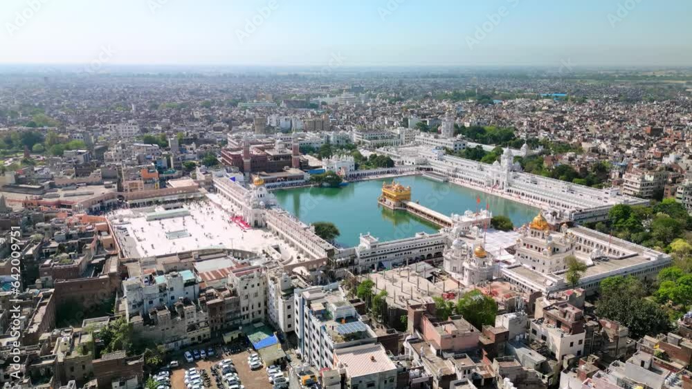 Amritsar, India: Aerial view of famous city in Punjab, iconic landmark The Golden Temple (Harimandir Sahib) - landscape panorama of South Asia from above