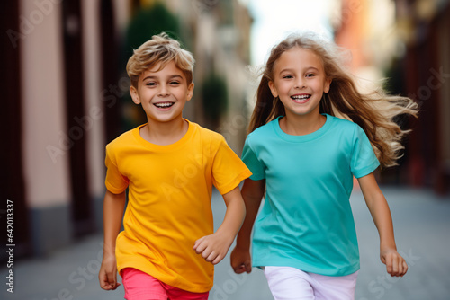 Young boy kid and girl model cheerful playing running together wearing colorful empty blank t-shirt