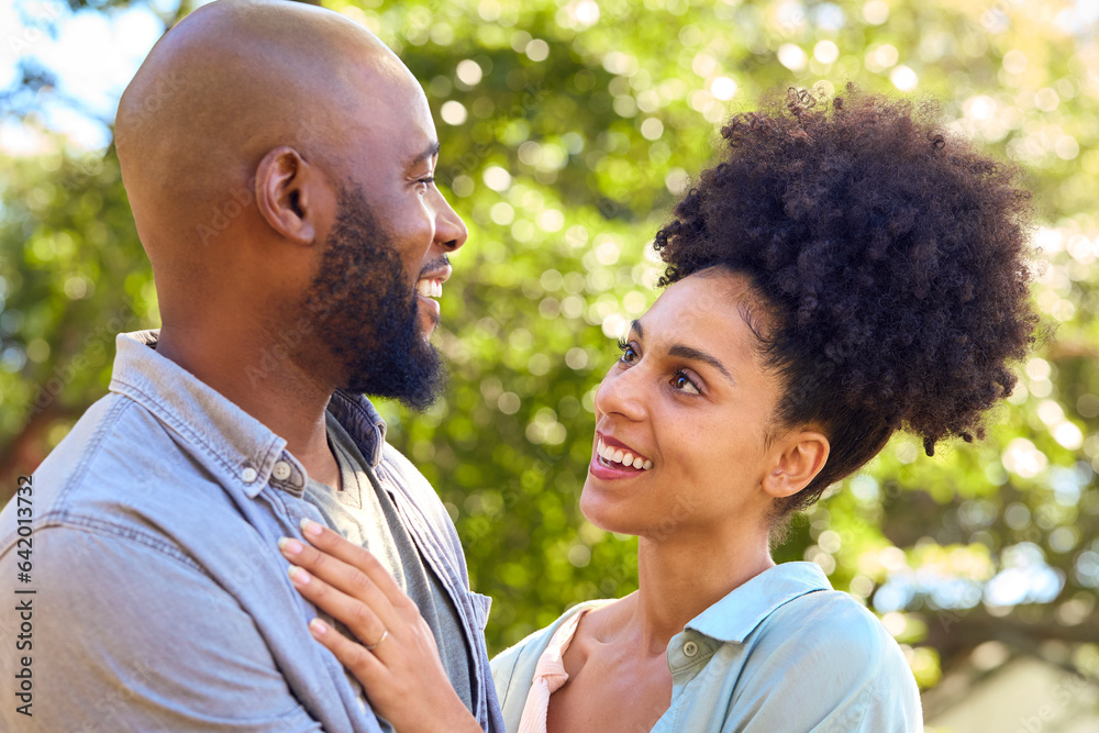 Loving Couple Standing Outdoors In Garden Park Or Countryside Hugging Loving Couple Standing Outdoors In Garden Park Or Countryside Hugging