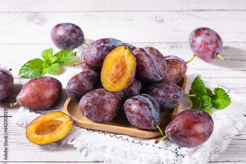 Fototapeta Naklejka Na Ścianę i Meble -  fresh ripe prune plum fruits on a wooden table, close-up