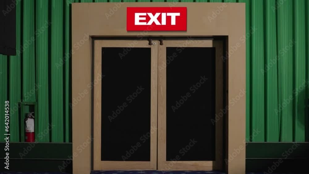 Exit doors in movie theater. Exit door in cinema at night. Emergency exit door at movie theater Exit doors in movie theater. Exit door in cinema at night. Emergency exit door at movie theater