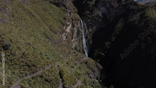 Experience the tranquility as the Candela Fasso waterfall gracefully recedes through picturesque mountain vistas photo