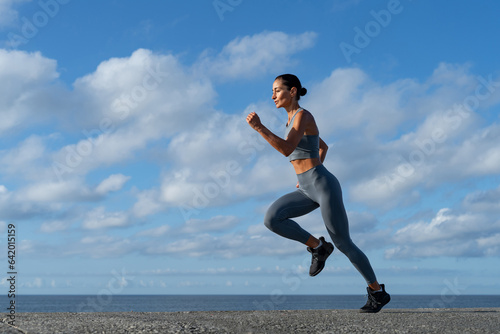 Fototapeta Naklejka Na Ścianę i Meble -  athletic brunette girl doing fitness doing exercises leading a healthy lifestyle