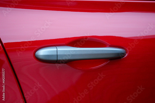 Stylish grey door handle on a new red vehicle