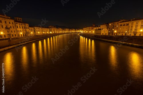 A romantic moment in the middle of the night on a bridge over the Arno in Pisa.