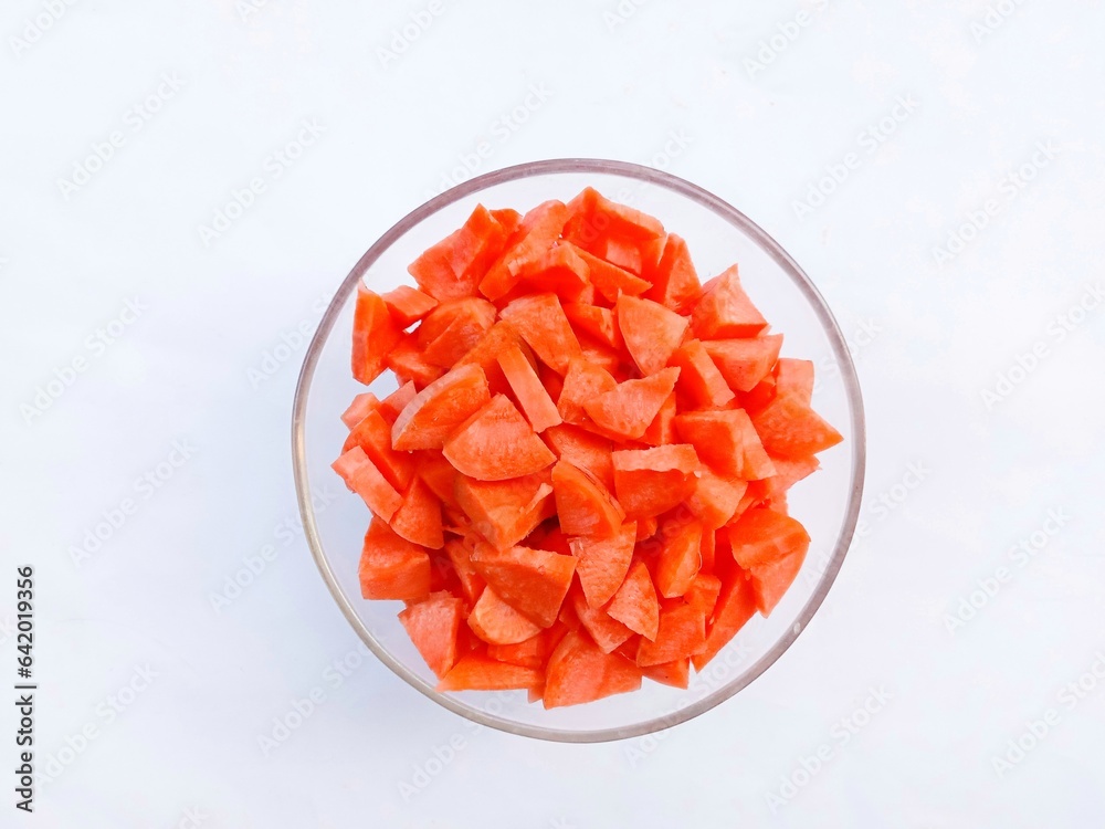 carrots in glass bowl. Slices of raw carrots in a glass bowl on a white background. vegetables. cooking preparation. healthy living.
carrots in glass bowl. Slices of raw carrots in a glass bowl on a white background. vegetables. cooking preparation. healthy living.