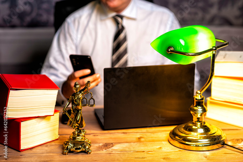 office of a lawyer with statue of Lady Justice, goddess Justitia, on the desk photo