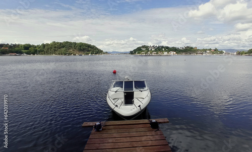 Single motorboat tied to dock in Oslo Fjord, Norway. photo