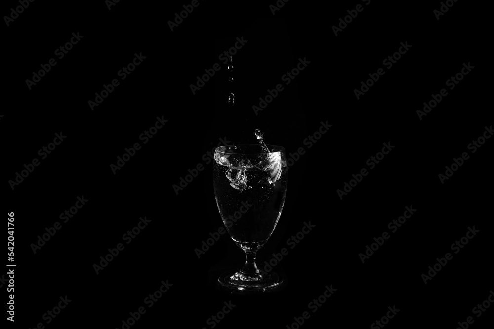 Water drops falling on glass isolated on a black background. Water drops falling on glass isolated on a black background.