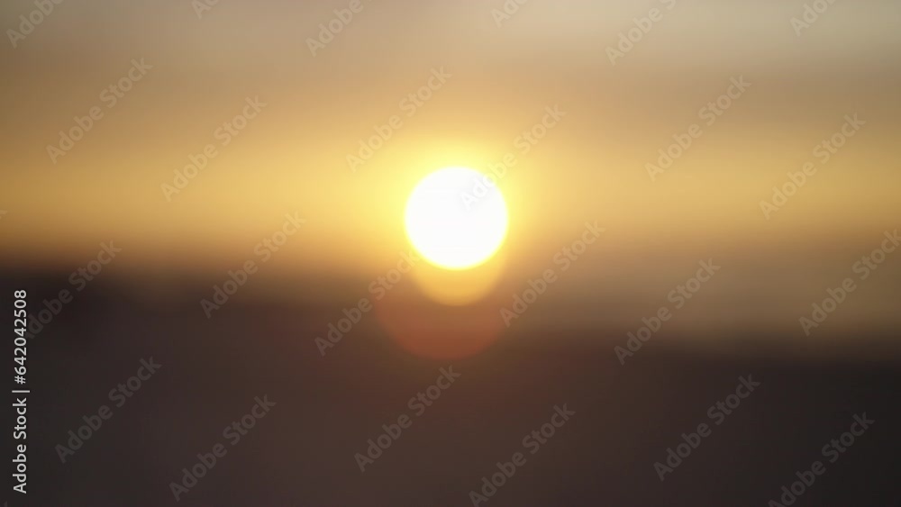 Distant golden sun setting over sea. Lovely setting sun at dusk Distant golden sun setting over sea. Lovely setting sun at dusk
