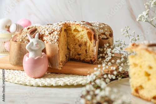 Delicious Italian Easter dove cake (traditional Colomba di Pasqua) and festive decor on white wooden table