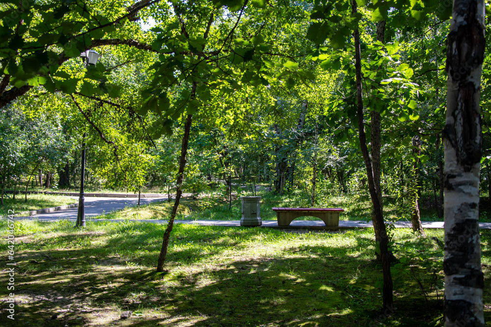 Scenic view of a winding stone path through a beautiful green park Scenic view of a winding stone path through a beautiful green park
