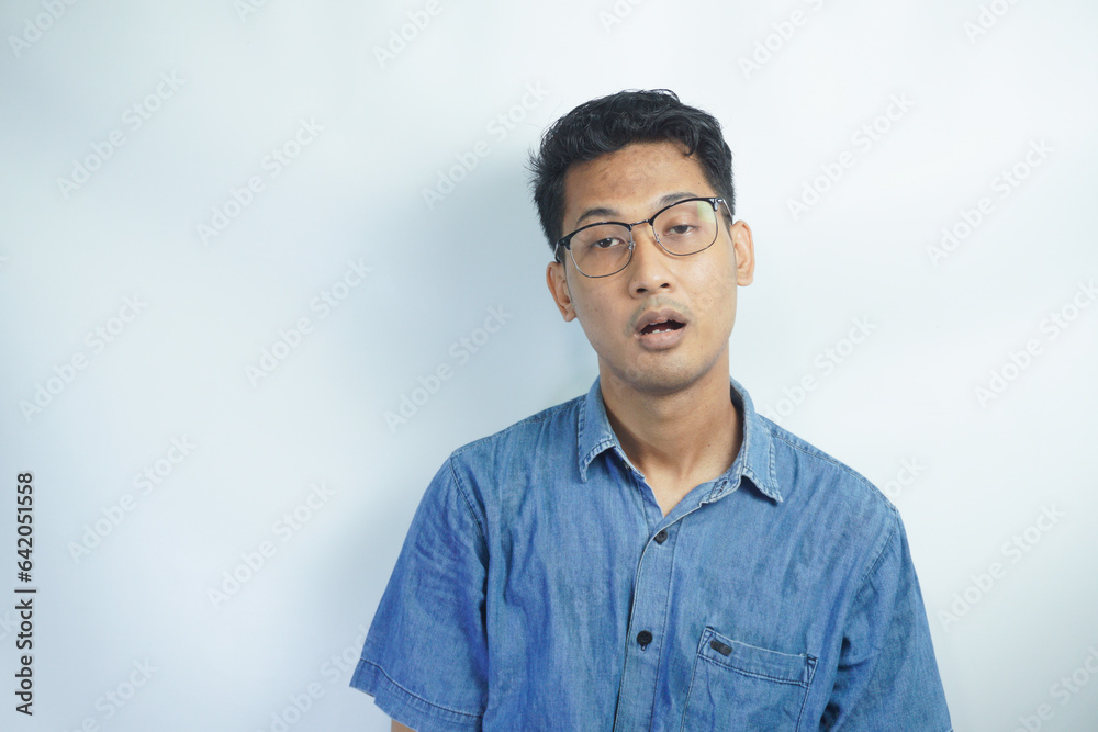 Asian man looks depressed and messed up. Tired and exhausted man, Concept of a bored and tired manstressed over work concept. Asian man looks depressed and messed up. Tired and exhausted man, Concept of a bored and tired manstressed over work concept.