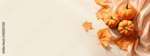 Autumn banner with leaves and pumpkins on pastel background
