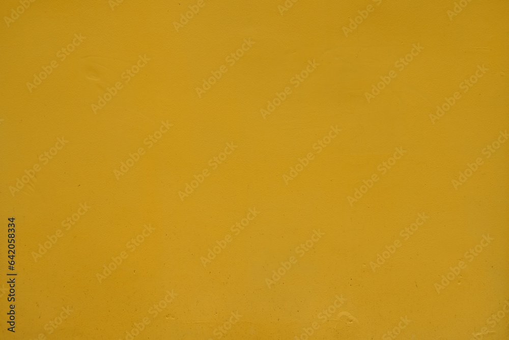 Surface of saffron yellow painted wall Surface of saffron yellow painted wall