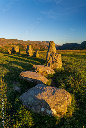 An ancient standing stone circle on high ground surrounded by mountains
