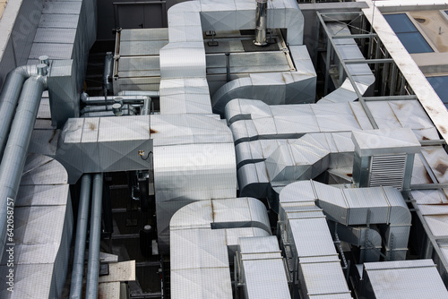Obraz na płótnie Ducts of the ventilation and air conditioning system on the roof of the building. The photo was taken in natural, soft light. View from above. w salonie