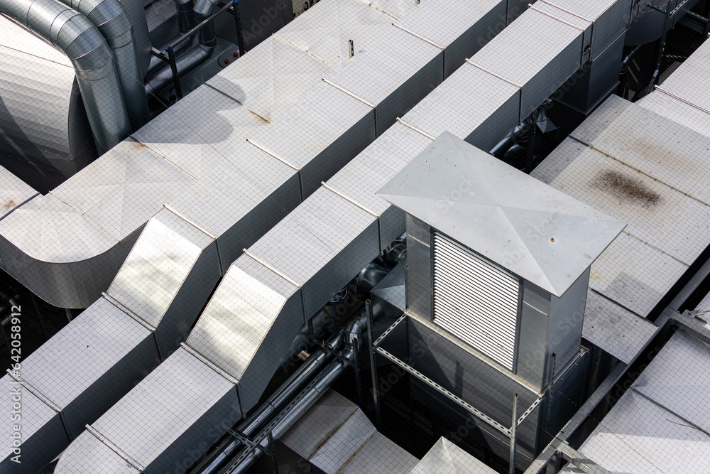Ducts of the ventilation and air conditioning system on the roof of the building. The photo was taken in natural, soft light. View from above.