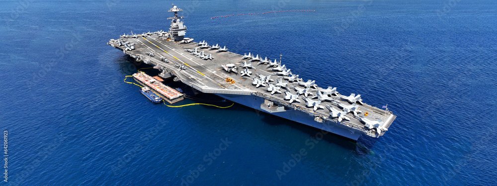 Aerial drone ultra wide panoramic photo with copy space of latest technology nuclear powered aircraft carrier USS Gerald R. Ford anchored in deep blue open ocean sea