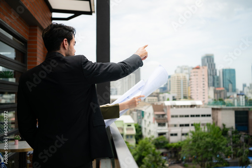 Businessman and businesswoman discussing project on the balcony of office building.