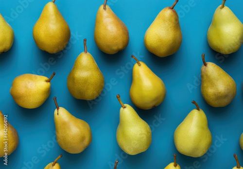 Yellow and green pears fruits on flat blue background