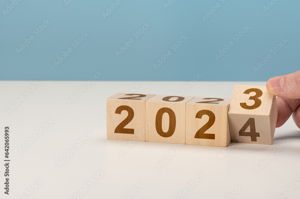 Φωτογραφία happy new year concept, Flipping of wooden cube block change from 2023 to 2024