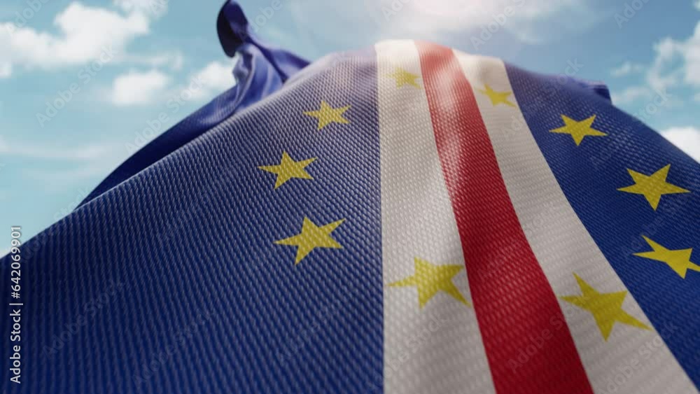 Wavy flag of Cape Verde blowing in the wind in slow motion. Waving colorful flag team symbol abstract vertical background. Blue sky with clouds. World countries flying flags concept