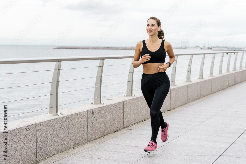 Motivation women engaged in fitness train. A person is a runner using a smartwatch for fitness, sportswear and running shoes.    Athlete training in sportswear.