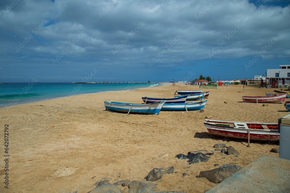 Obraz premium Boats in Vila do Maio, Island in Cape Verde boasts exquisite beaches. With their soft sands, azure waters, and tranquil ambiance, they offer a serene tropical paradise.