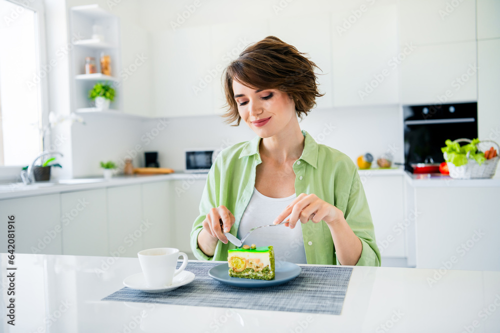 Photo of dreamy cute lady dressed green shirt eating sweet tasty dessert indoors house kitchen