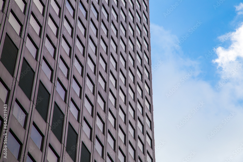 Window office building in Tokyo city against blue sky with cloud Window office building in Tokyo city against blue sky with cloud