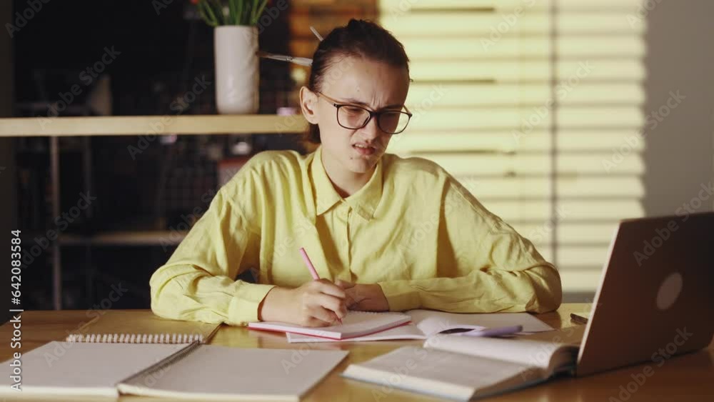 Boring tired young student freelancer studying or working at home workplace Sleepy female with glasses exhausted from remote distance work or education and hard program indoors Boring tired young student freelancer studying or working at home workplace Sleepy female with glasses exhausted from remote distance work or education and hard program indoors