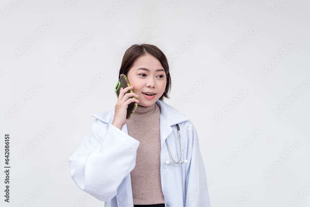 Portrait of a young and skilled doctor, medical student, intern talking to someone on the phone. Isolated on a white background. Portrait of a young and skilled doctor, medical student, intern talking to someone on the phone. Isolated on a white background.