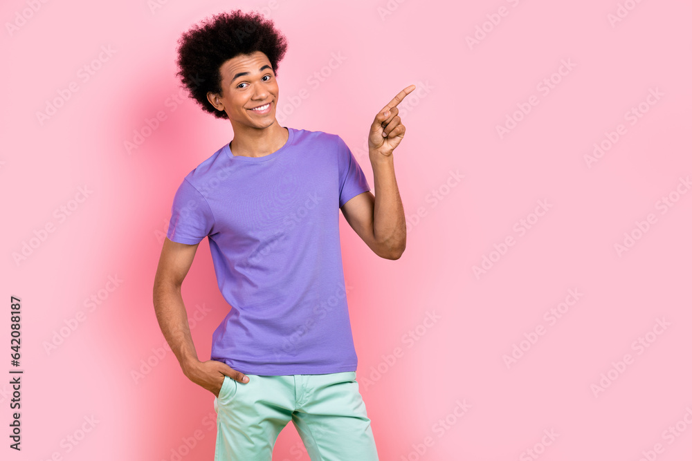 Photo of funky cheerful man wear stylish violet clothes arm demonstrate cool offer empty space isolated on pink color background Photo of funky cheerful man wear stylish violet clothes arm demonstrate cool offer empty space isolated on pink color background