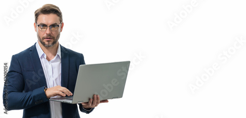 Business man in suit using laptop. Male businessman worker hold computer laptop. Serious man hold laptop computer. Caucasian male worker in glasses work with laptop, isolated web banner. photo