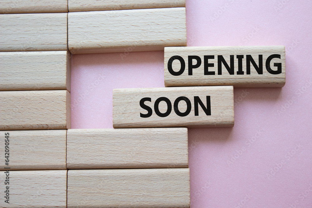 Opening soon symbol. Concept word Opening soon on wooden blocks. Beautiful pink background. Business and Opening soon concept. Copy space Opening soon symbol. Concept word Opening soon on wooden blocks. Beautiful pink background. Business and Opening soon concept. Copy space