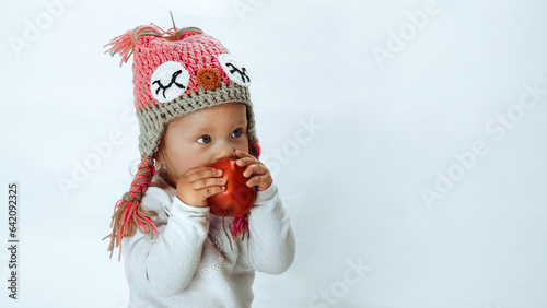 Baby girl enjoying aroma of an apple