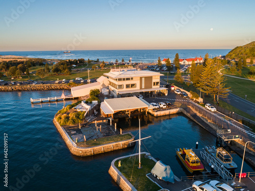 Moon rising over Nobbys beach headland in Newcastle with marina