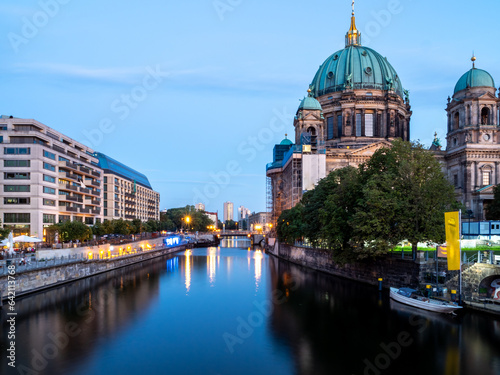 View of the city river at the cathedral in Berlin at sunset. Landscape of the evening city