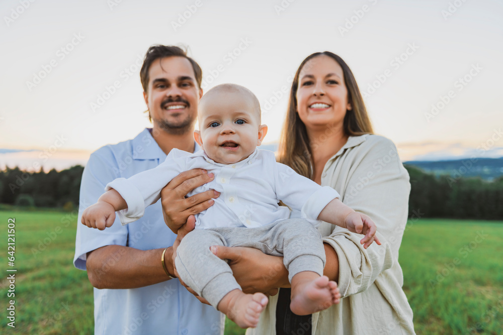 Happy family with baby boy on nature sunset Happy family with baby boy on nature sunset