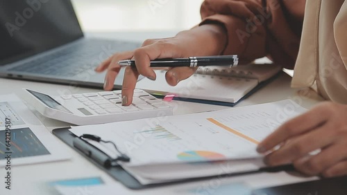 Businesswoman or accountant working Financial investment on calculator, calculate, analyze business and marketing growth on financial document data graph, Accounting, Economic, commercial concept.