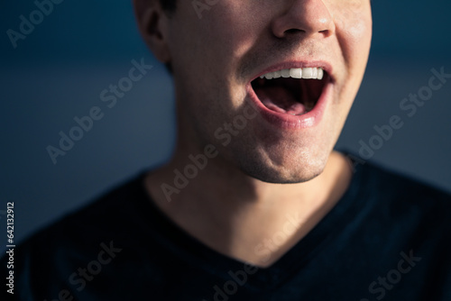 Sing, talk or speak. Singer mouth open. Man with loud sound of voice. Pronunciation in language education, articulation exercise or vocal lesson. Song in music studio. Speech or karaoke. Yell or shout photo
