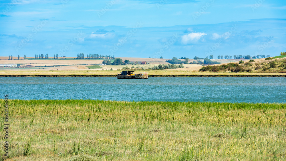 Wrecked Boat in the Swale Estuary in Oare near Faversham - Kent with the Isle of Sheppey in the distance