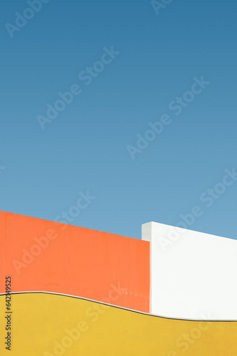 Colorful shape of building wall against blue sky