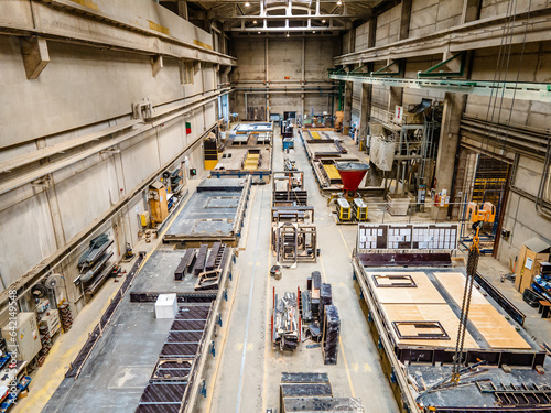 The interior of a big industrial building or factory with steel and concrete constructions