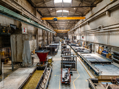 The interior of a big industrial building or factory with steel and concrete constructions