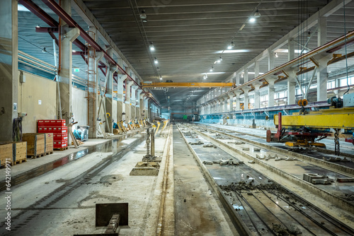 The interior of a big industrial building or factory with steel and concrete constructions