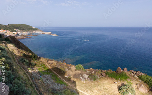 Aerial view from the blue Sardinian sea, rock coast