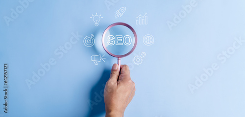 business, document, management, file, search, seo, light bulb, folder, professional, network. close up to hand, hold magnifier to search solution too seo and advertise to hit the goal and target.