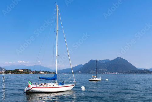 Two sailing boats anchored on one of the largest freshwater Lake Como in the Lombardy region in northern Italy. 